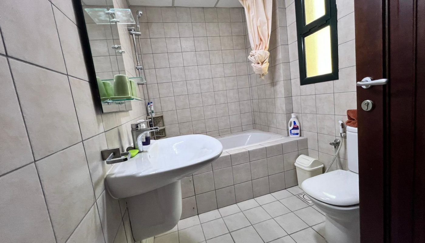 Elevate your living experience in this Juffair bathroom, complete with a toilet, sink, and shower.