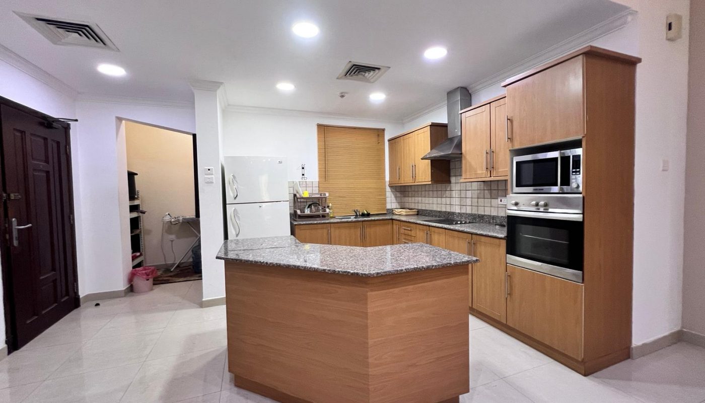 Elevate your living experience with a dream home featuring a kitchen with a wooden counter top and stainless steel appliances.