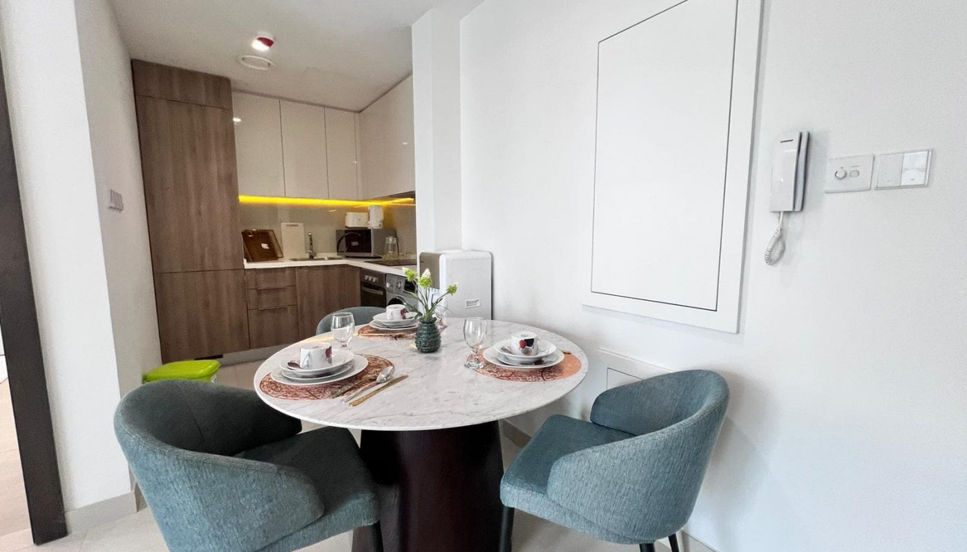 A dining table and chairs in a Modern Living apartment.