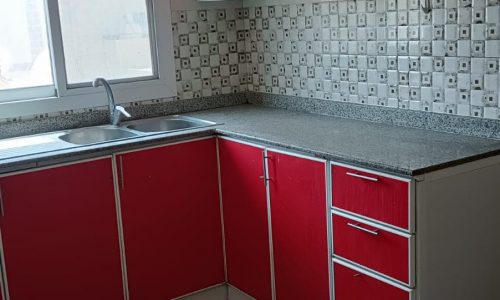 A kitchen with red cabinets.