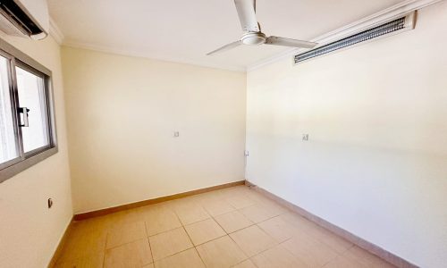 A spacious villa with a tiled floor and a ceiling fan.