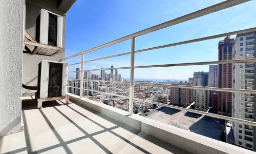 An apartment with a balcony and view of the city for sale in Juffair.