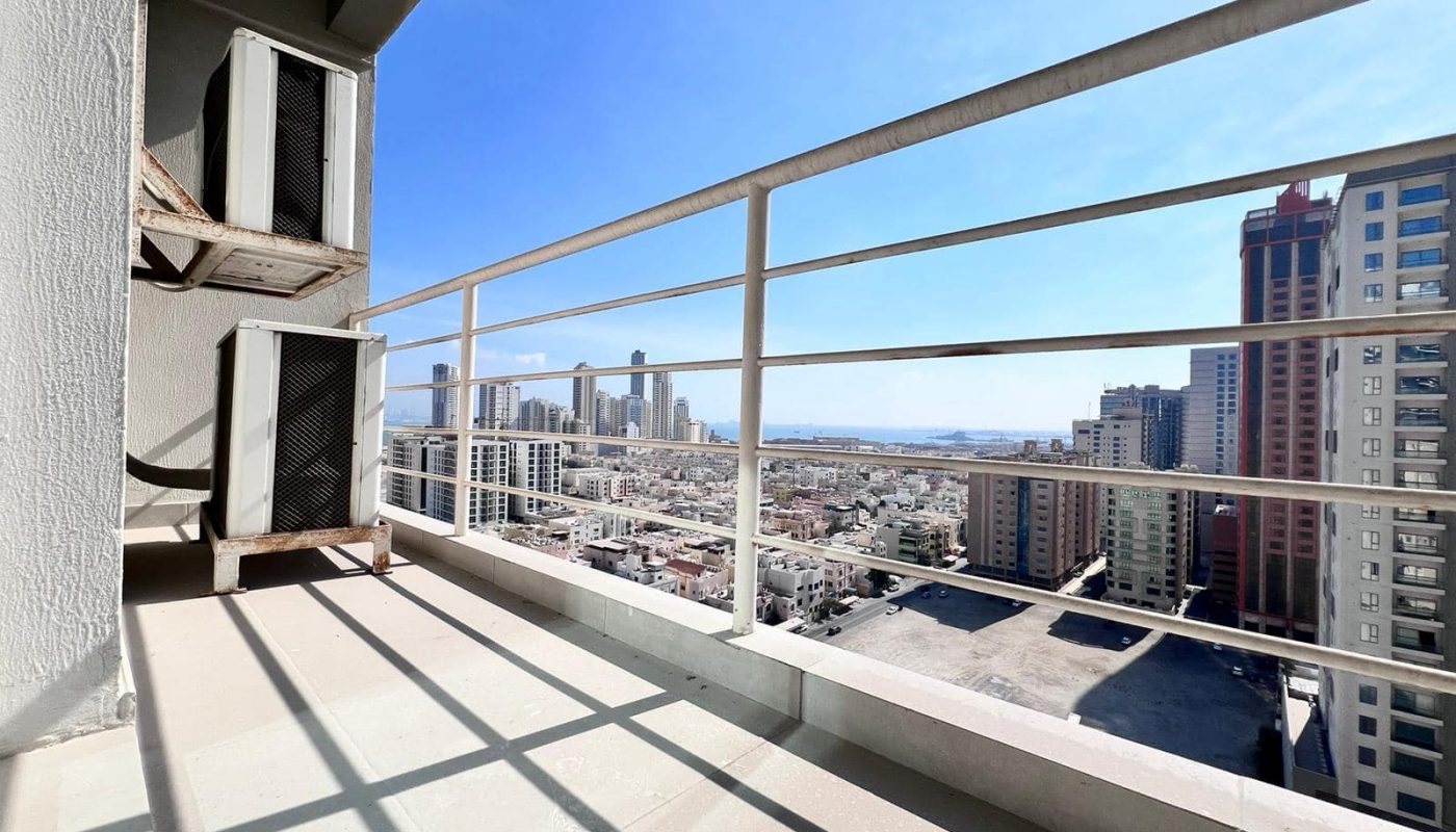 An apartment with a balcony and view of the city for sale in Juffair.