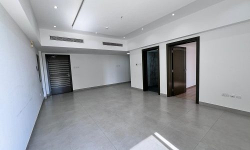 A spacious apartment for sale in Juffair with white walls and doors.