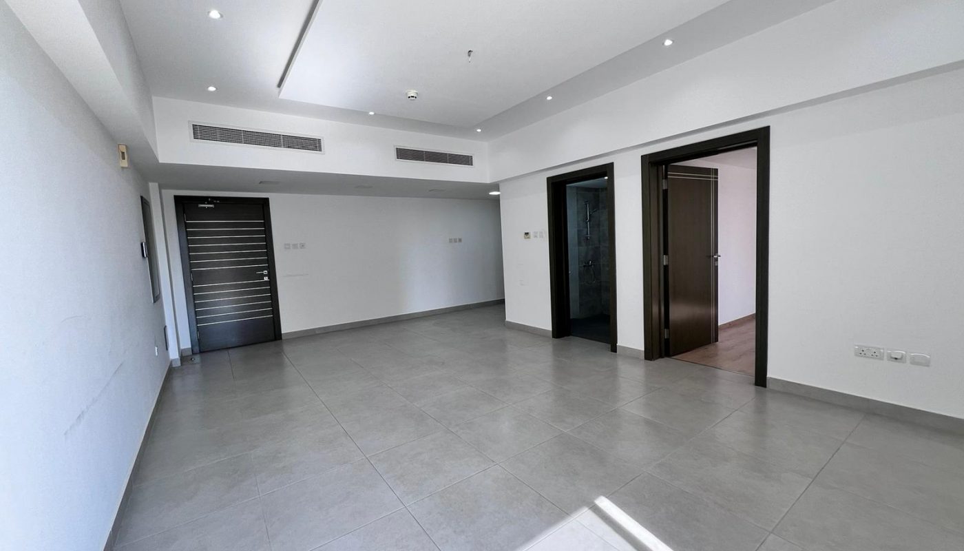 A spacious apartment for sale in Juffair with white walls and doors.
