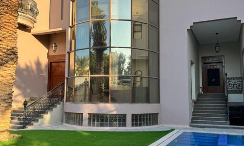 A villa with a swimming pool in front of it available for rent in Juffair.