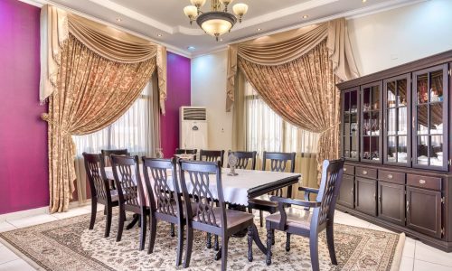 A dining room with a table and chairs located in a villa.