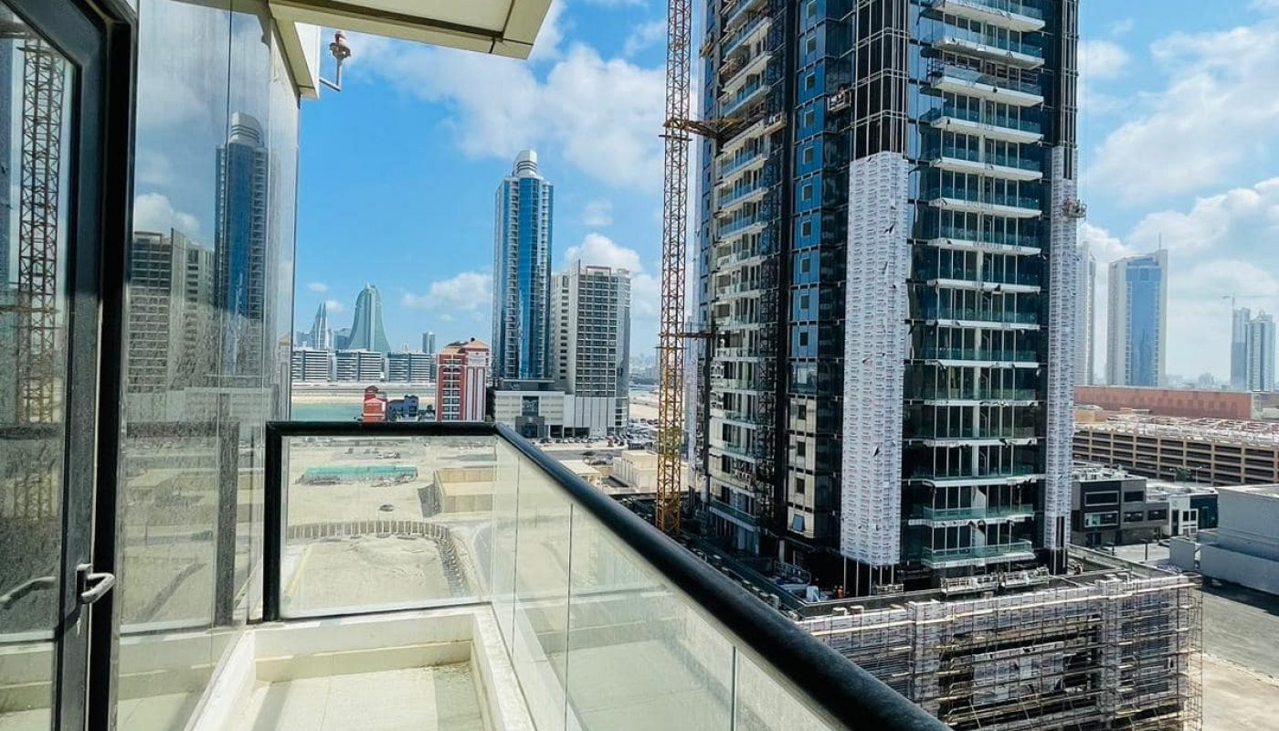 A luxury 1BR apartment with a balcony overlooking the city in Seef.