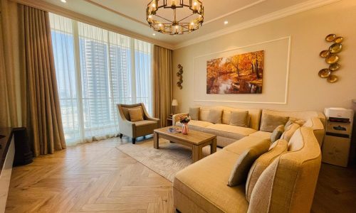 A living room with wooden floors and a tv.