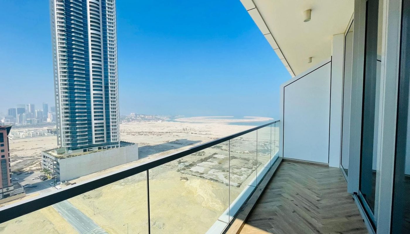A balcony with a view of the city and skyscrapers.