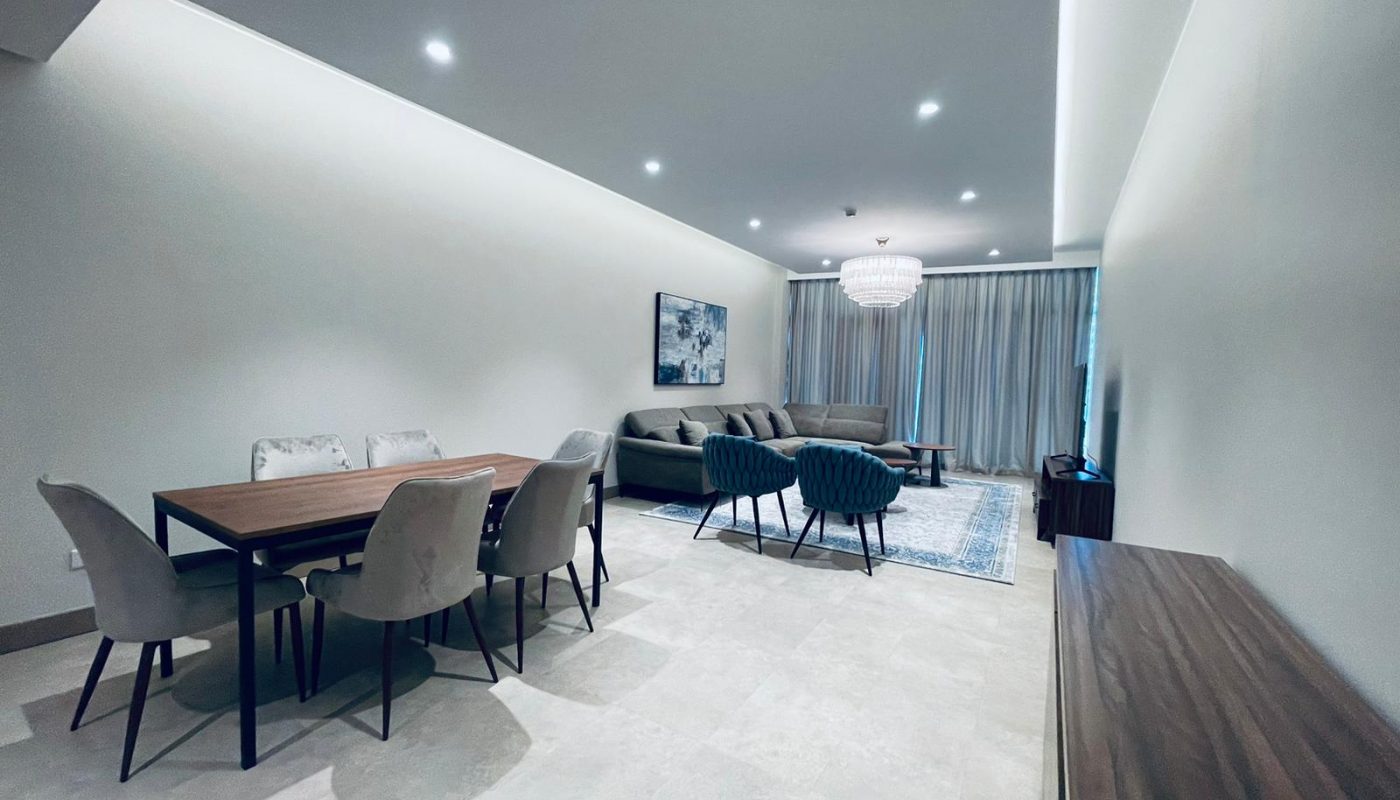 A living room and dining room in a modern apartment with a sleek design.