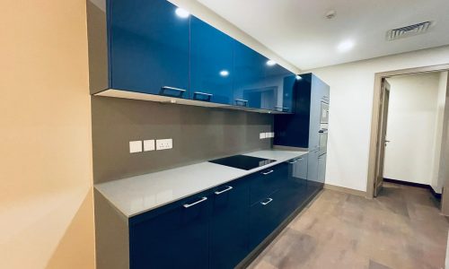 Auto Draft: An empty kitchen with blue cabinets and wood floors is a serene space, perfect for cooking and gathering with family.