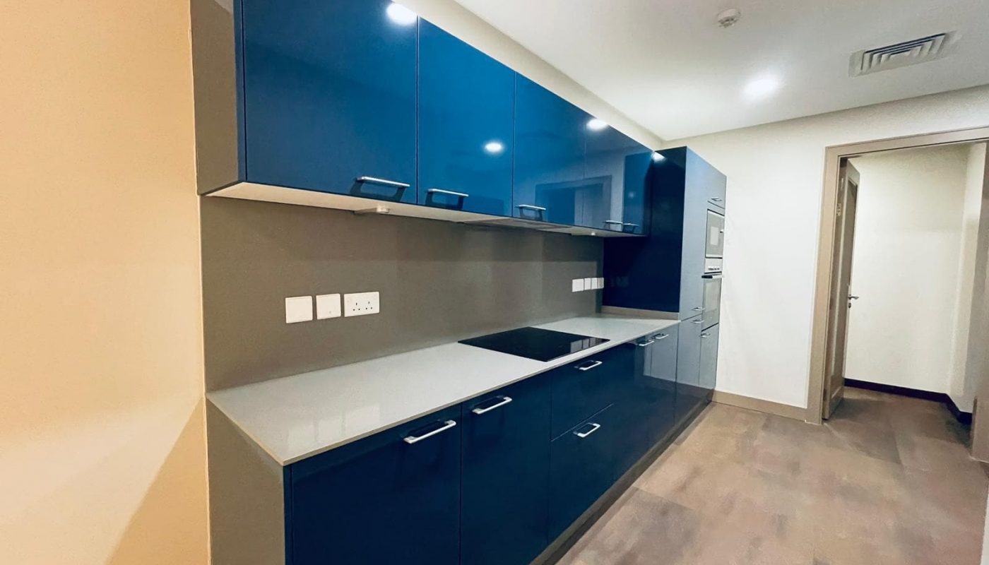 Auto Draft: An empty kitchen with blue cabinets and wood floors is a serene space, perfect for cooking and gathering with family.