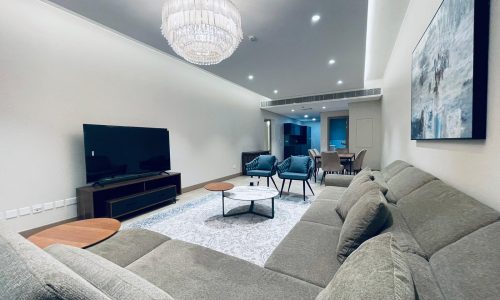 A living room with comfy couches and a TV.