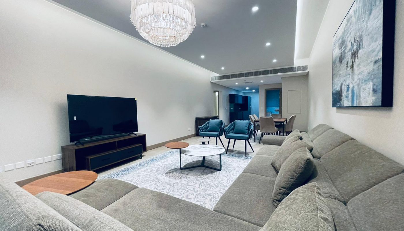 A living room with comfy couches and a TV.