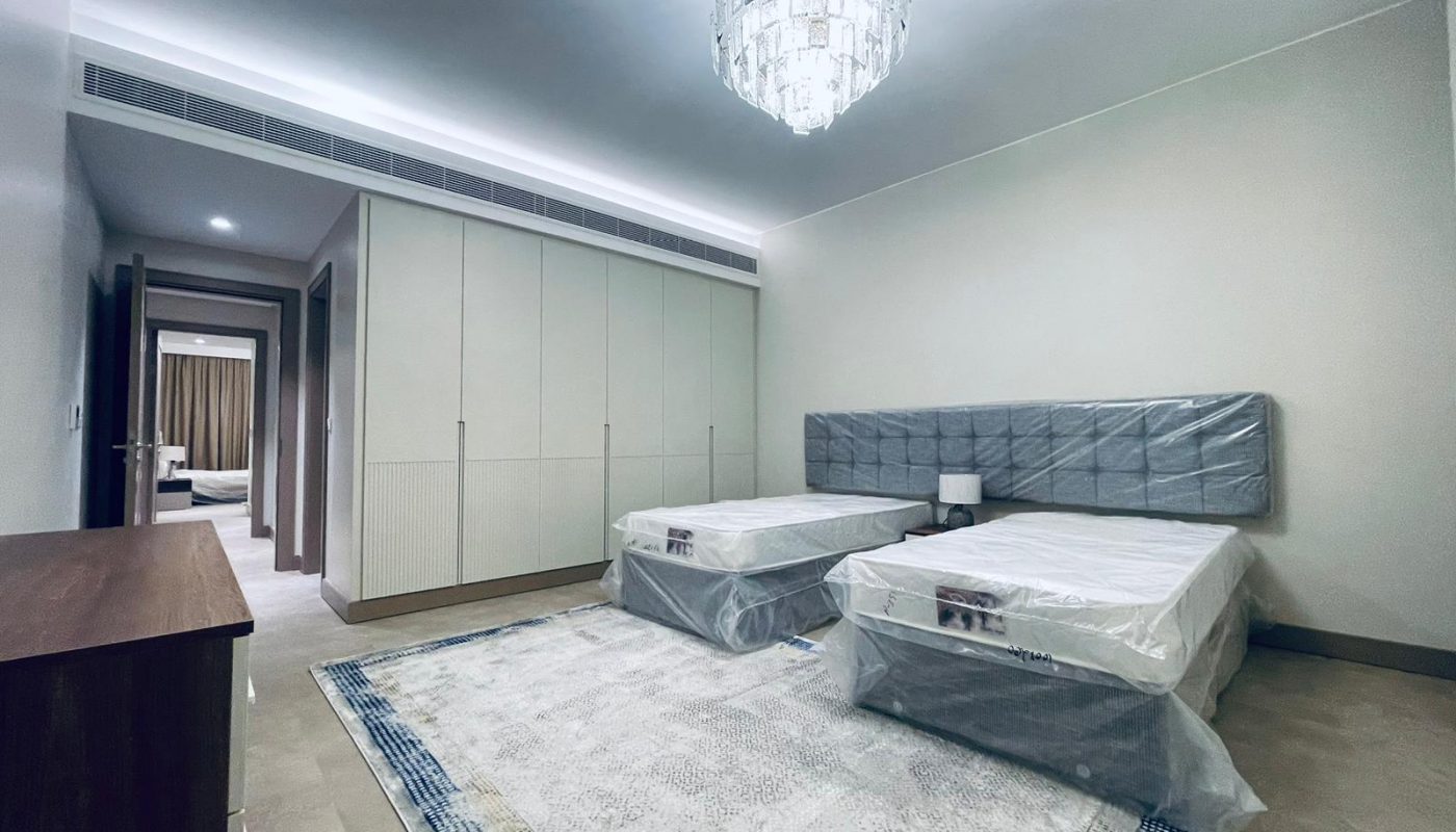 A bedroom with two beds and a chandelier designed using AutoCAD software.