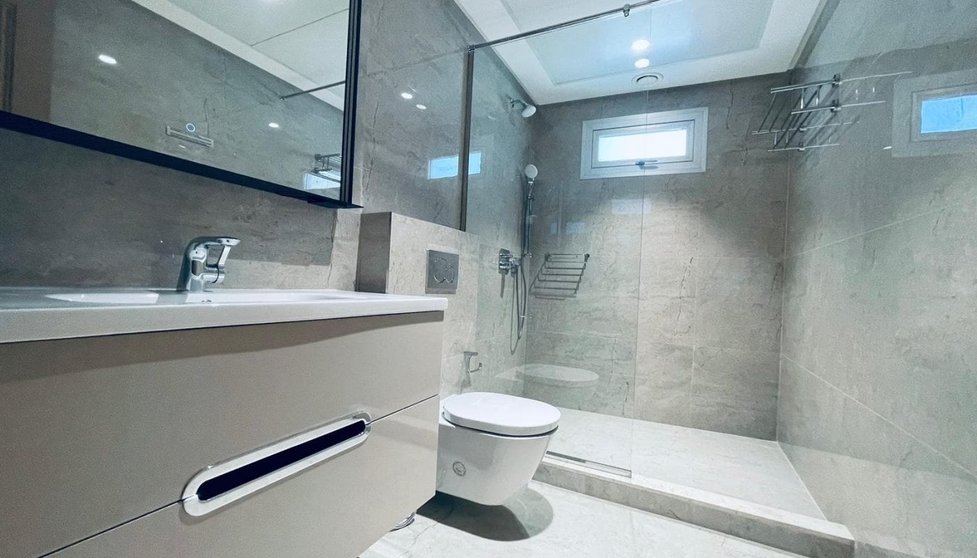 A modern bathroom with a glass shower and toilet, perfect for SEO optimization.