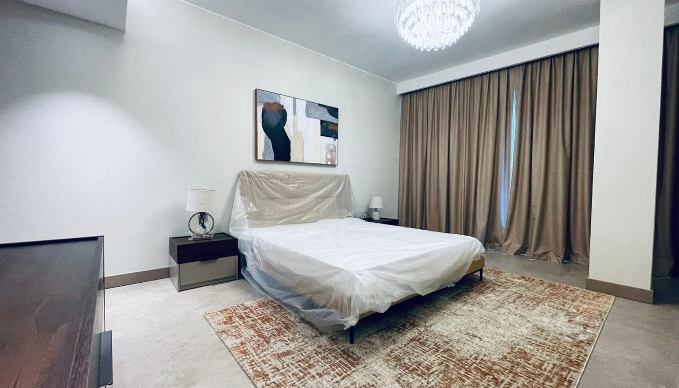 Auto Draft: A bedroom with a large bed and a bedside table.