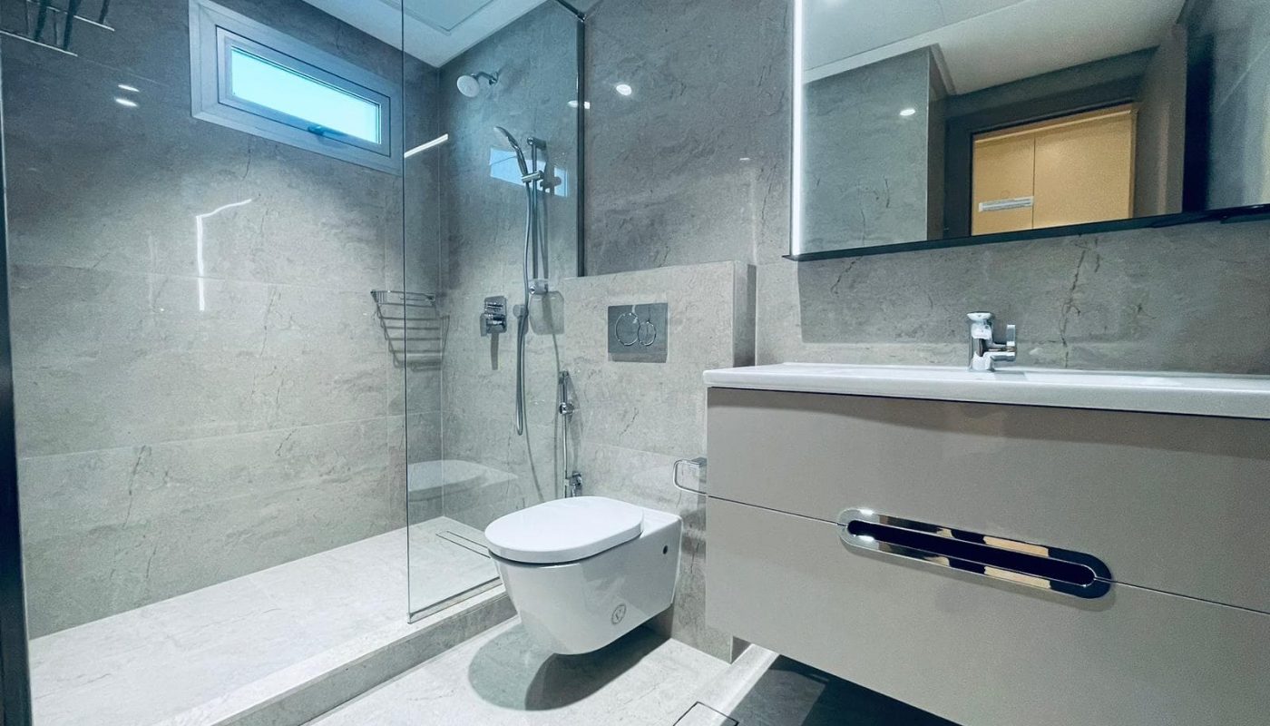 A modern bathroom with a glass shower stall and toilet designed for SEO.