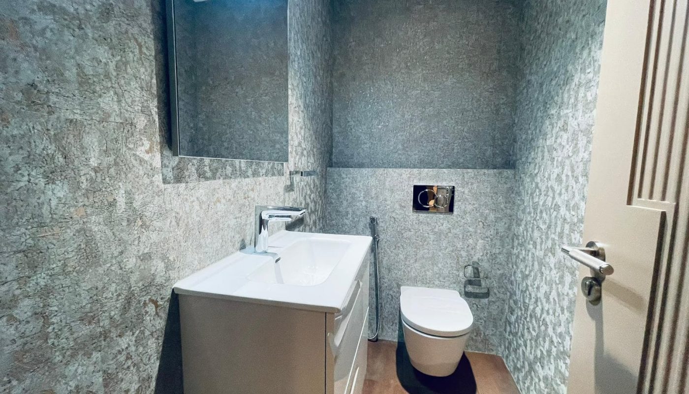 A small bathroom with a toilet and sink.