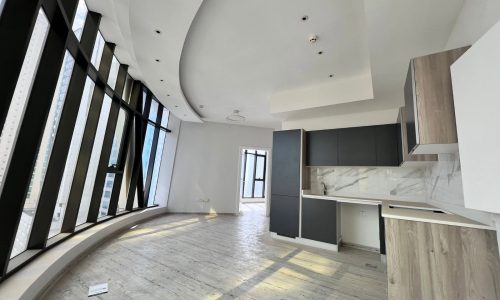 A luxury apartment in Seef with large windows and a wooden floor.