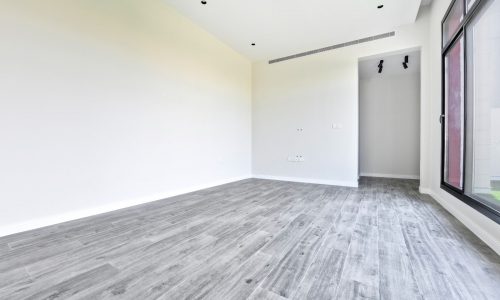 Auto Draft: Empty modern room with grey flooring and white walls with large window.