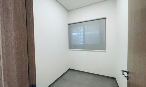 Small empty room with an auto draft, an open door, and a frosted glass window.