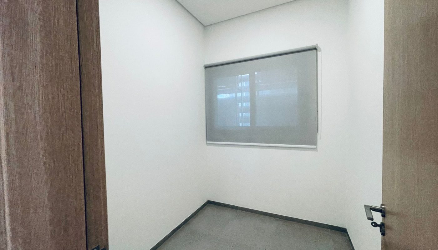 Small empty room with an auto draft, an open door, and a frosted glass window.