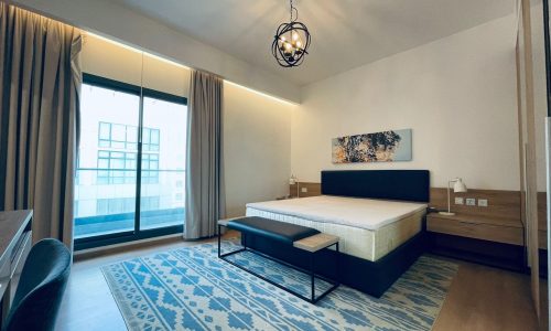 Modern bedroom interior with a king-sized bed, patterned rug, and Auto Draft warm lighting.