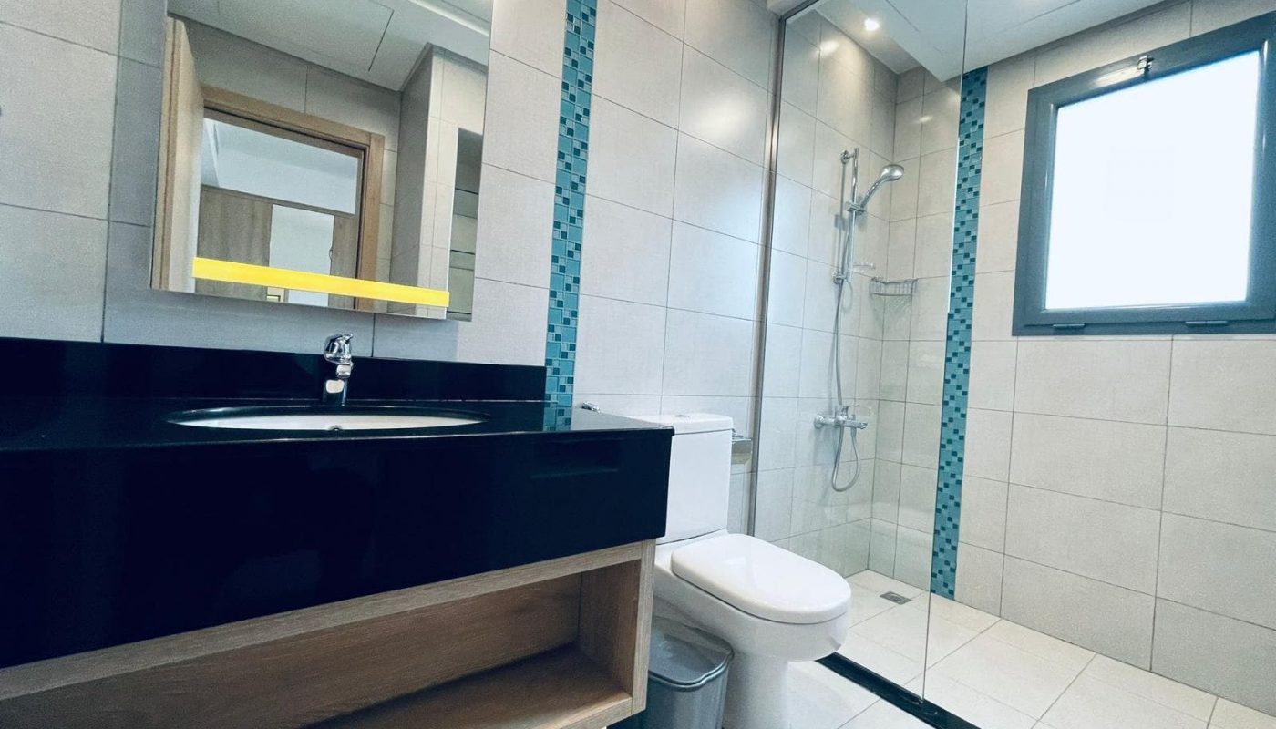 Modern bathroom interior with a black countertop sink, mirror, toilet, walk-in shower, and Auto Draft.