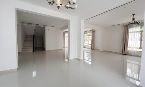 A spacious, empty room with glossy tiled flooring, white walls, and a staircase leading to an upper level is saved as an Auto Draft.