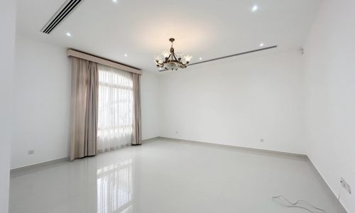 An empty, well-lit room with white walls, glossy floor tiles, and a window with light curtains is available for Auto Draft.