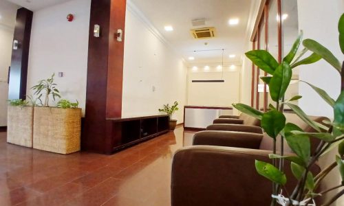 Modern lobby area with comfortable seating, indoor plants, and situated in a prime location.