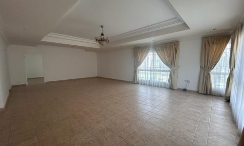 Spacious empty room with tiled flooring and large curtained windows. Auto Draft