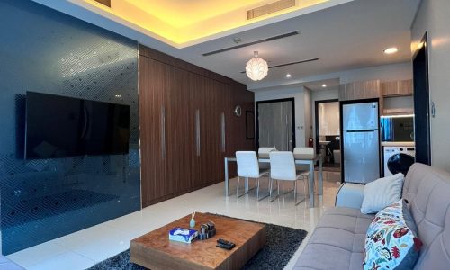 Luxury living room in a modern apartment, featuring white sofas, a wooden coffee table, shaggy gray rug, and ambient ceiling lighting.