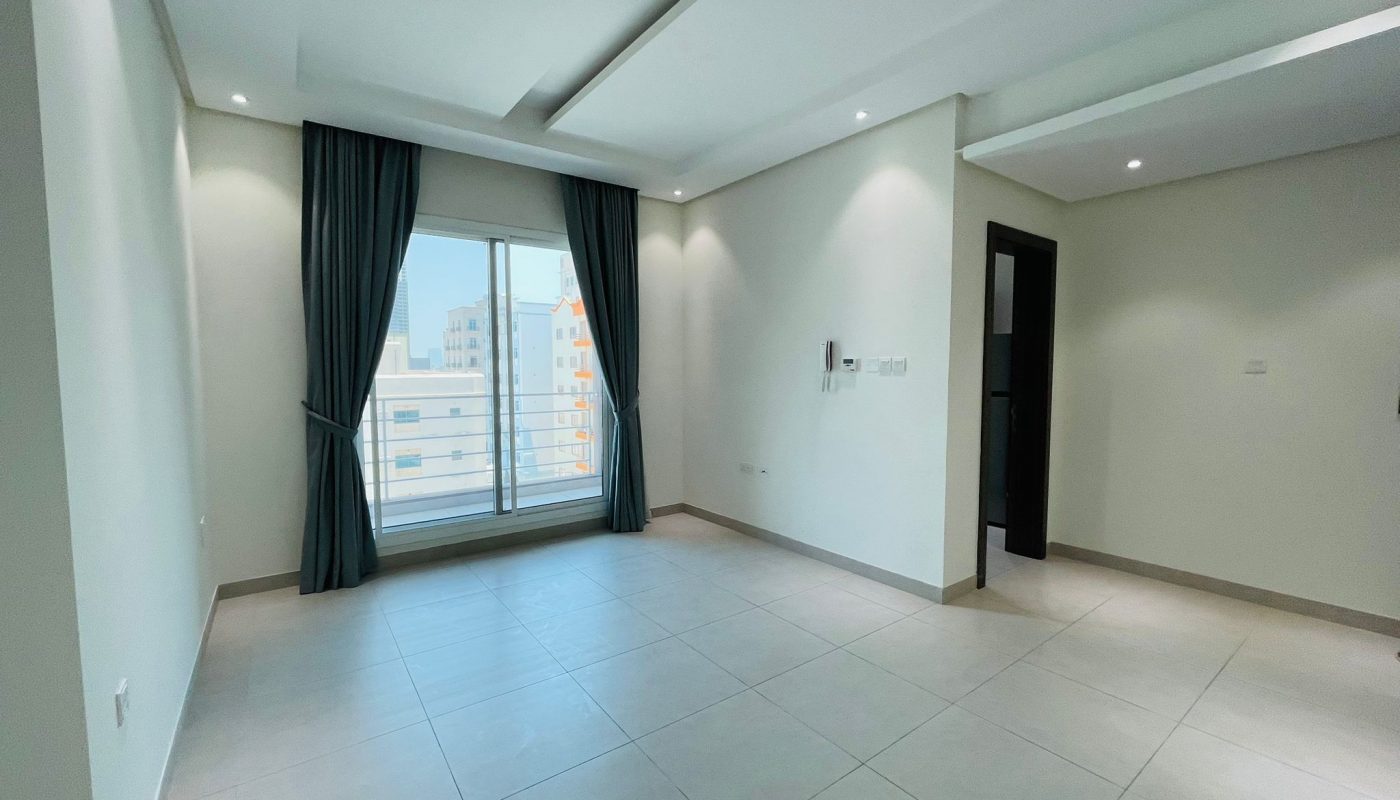 Apartment for rent: Modern interior with white walls, large window with dark curtains, and tiled flooring.
