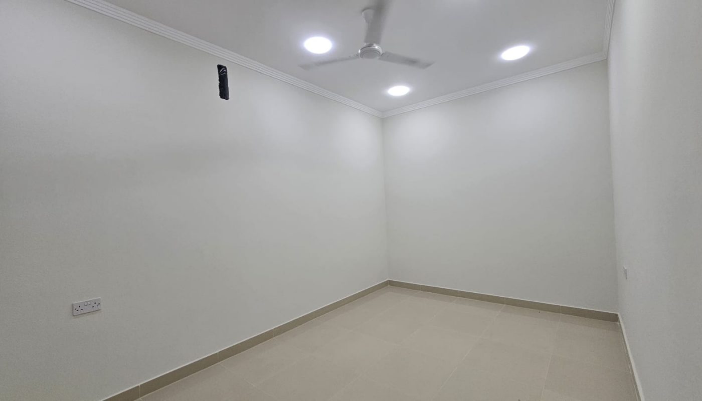 Empty room with white walls, beige tiled floor, ceiling fan, recessed lights, and an exposed wire hanging from the ceiling.