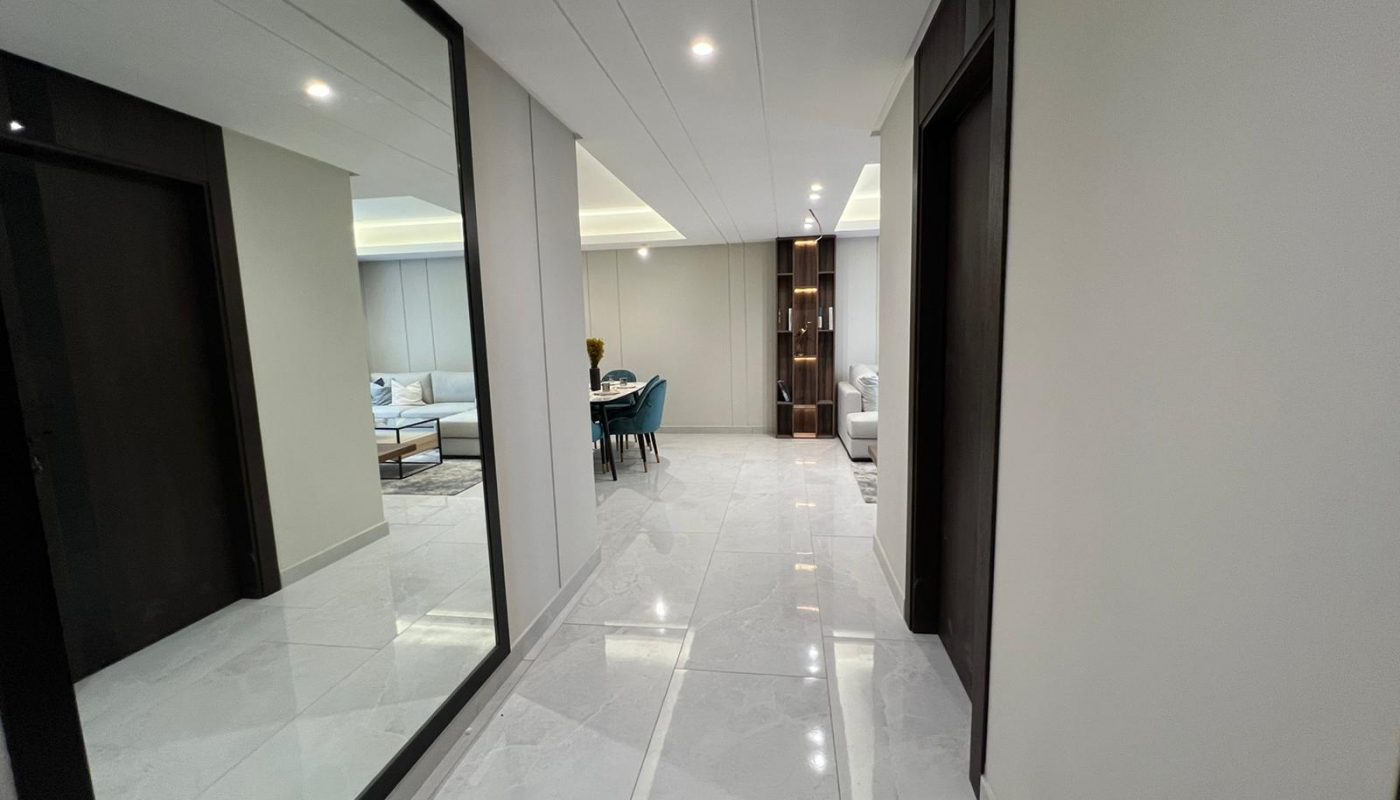 A hallway with a mirror in the middle, located in Amwaj Island.