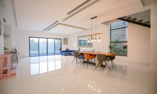 An eye-catching modern kitchen and dining room in a modern home for sale in Al Qurrayah.