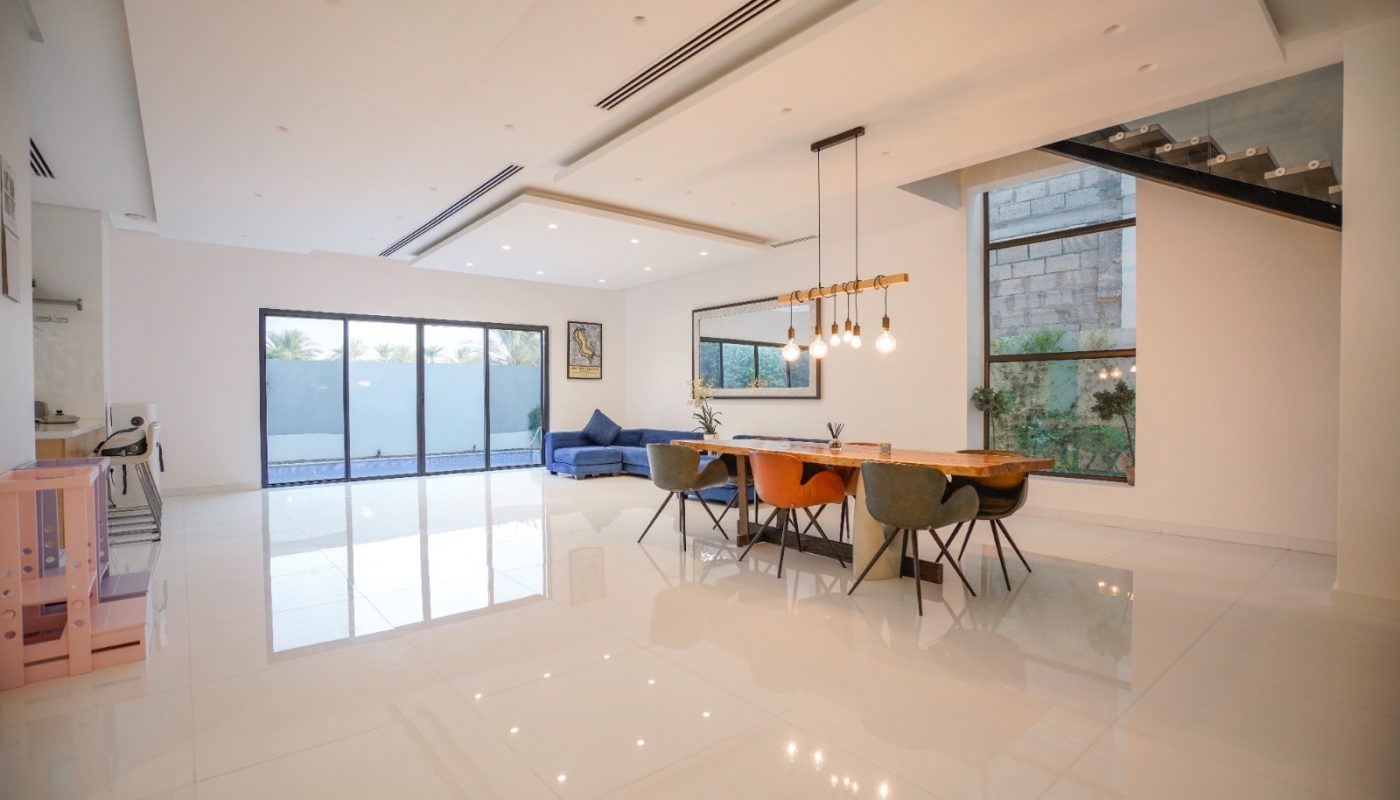 An eye-catching modern kitchen and dining room in a modern home for sale in Al Qurrayah.
