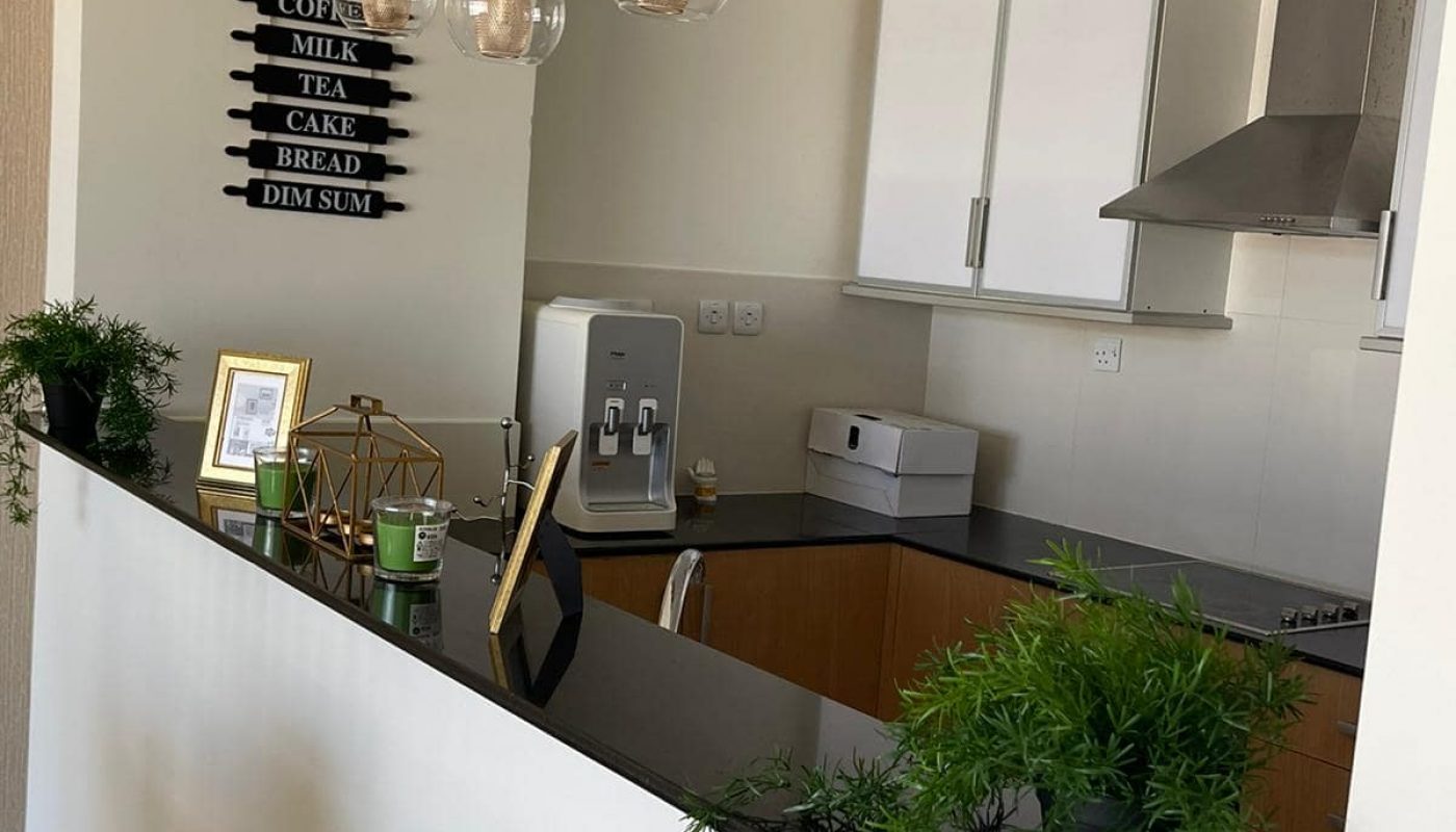 Immaculate modern kitchen with black counter top in 2BR Apartment for Sale in Amwaj Island.