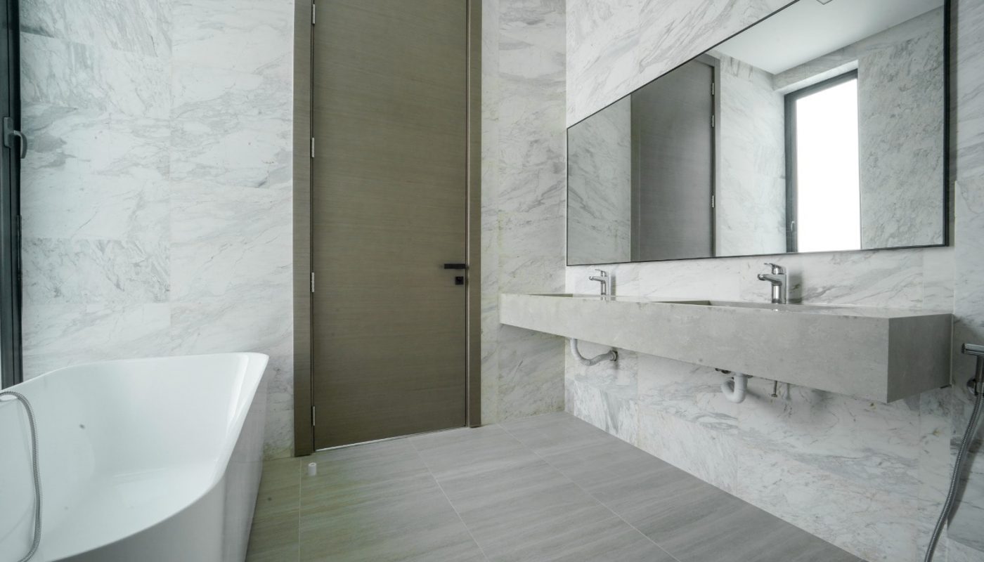 An opulent bathroom with white walls and marble floors in a modern villa.
