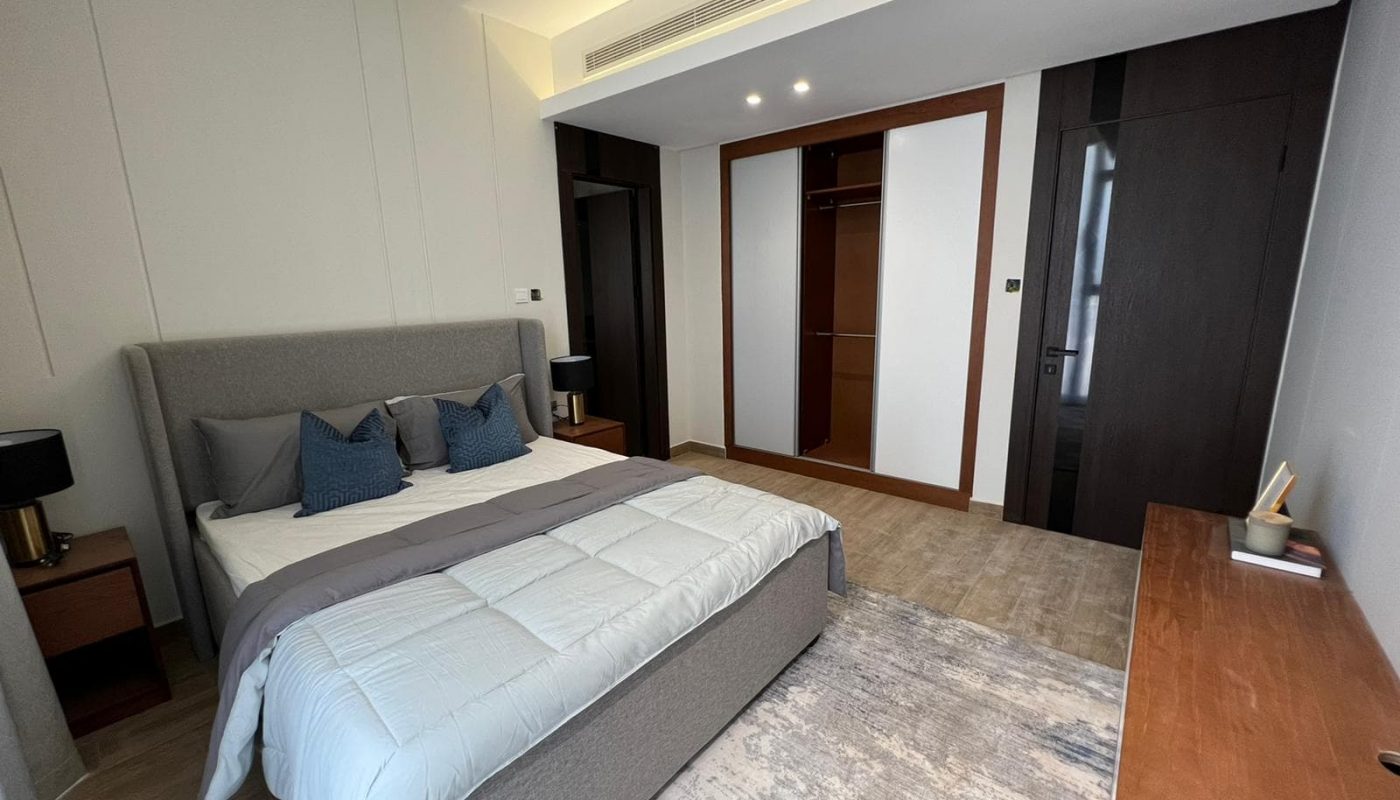 A stunning bedroom with a bed and a dresser.