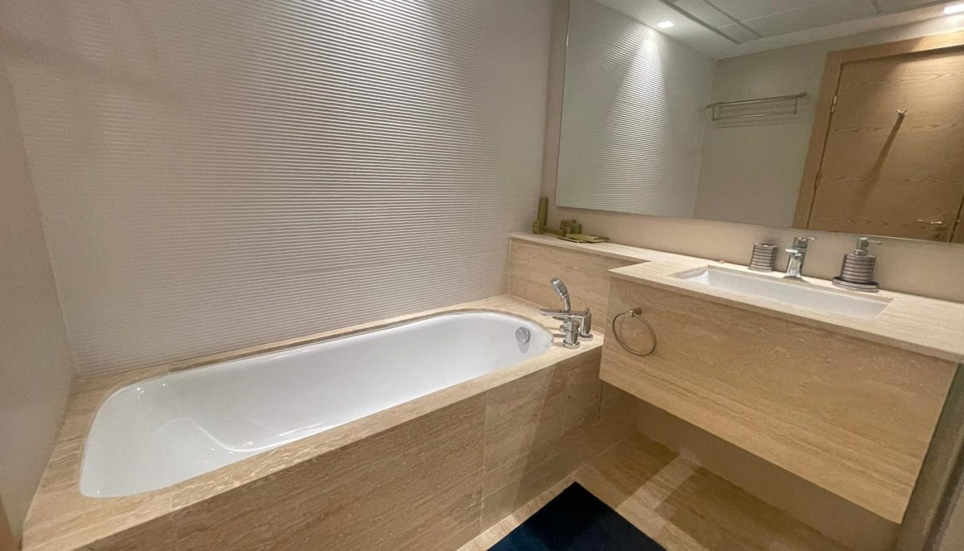 An elegant bathroom in an FF apartment with a bathtub and sink.