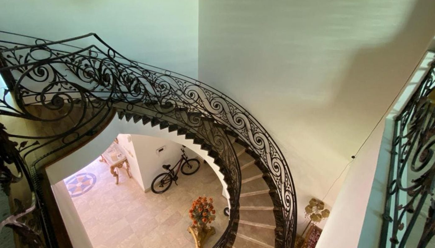 A Galali villa with an ornate spiral staircase.