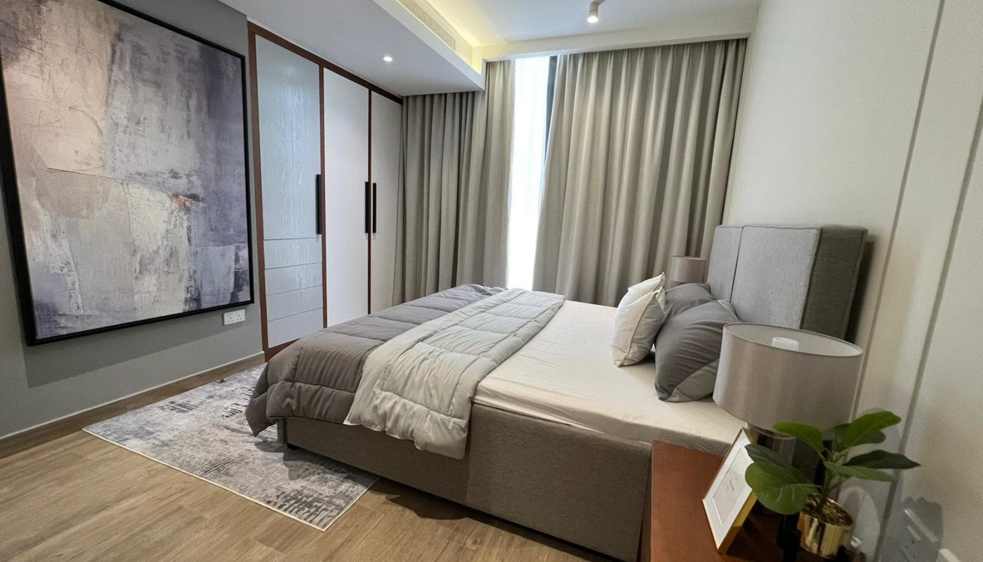 A stunning bedroom with a bed and a painting on the wall.