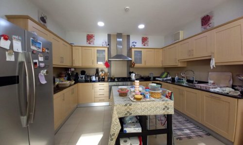 Beautiful kitchen with stainless steel appliances and a refrigerator.