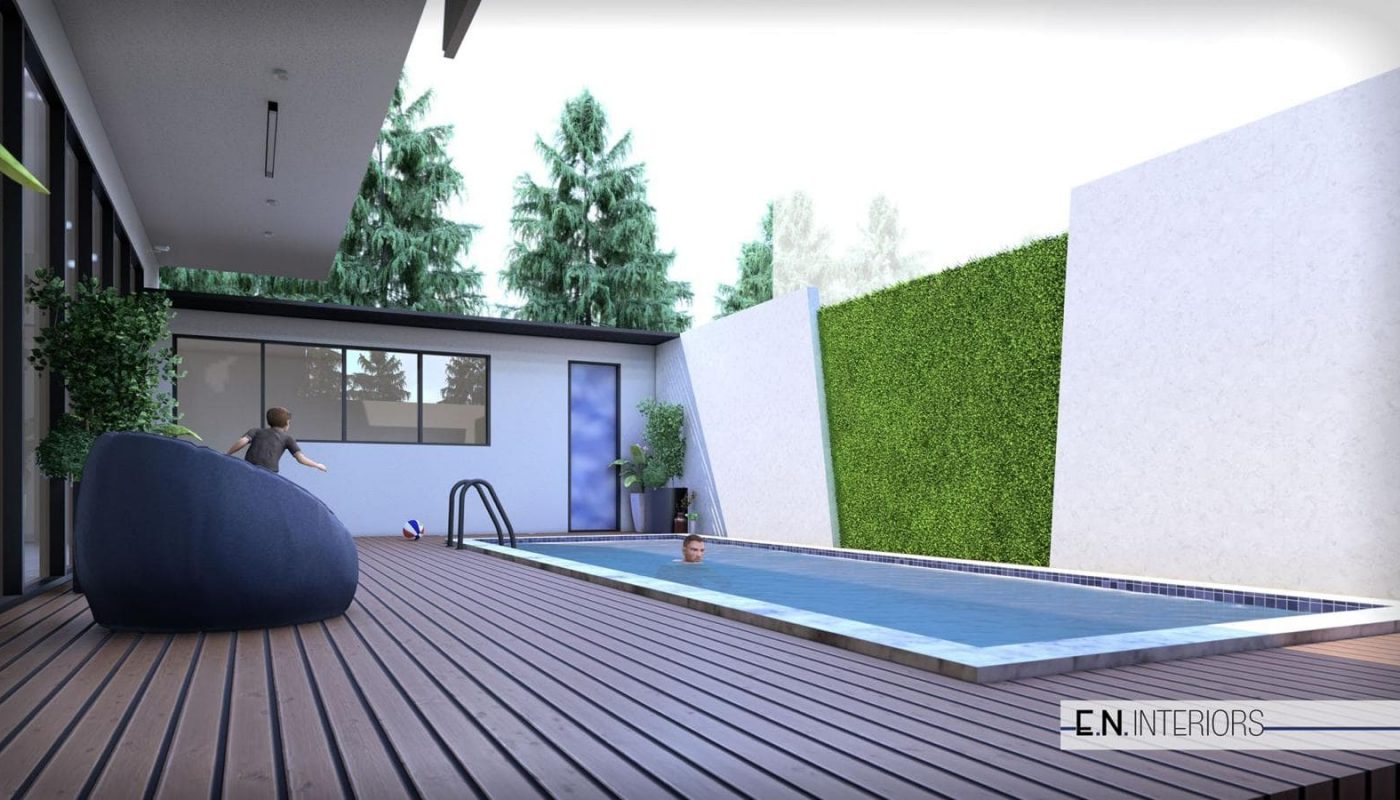 Modern outdoor pool area with wooden deck, green hedge, and a small pool. A child plays near the water, and there's a large, dark seating object. Trees are in the background.