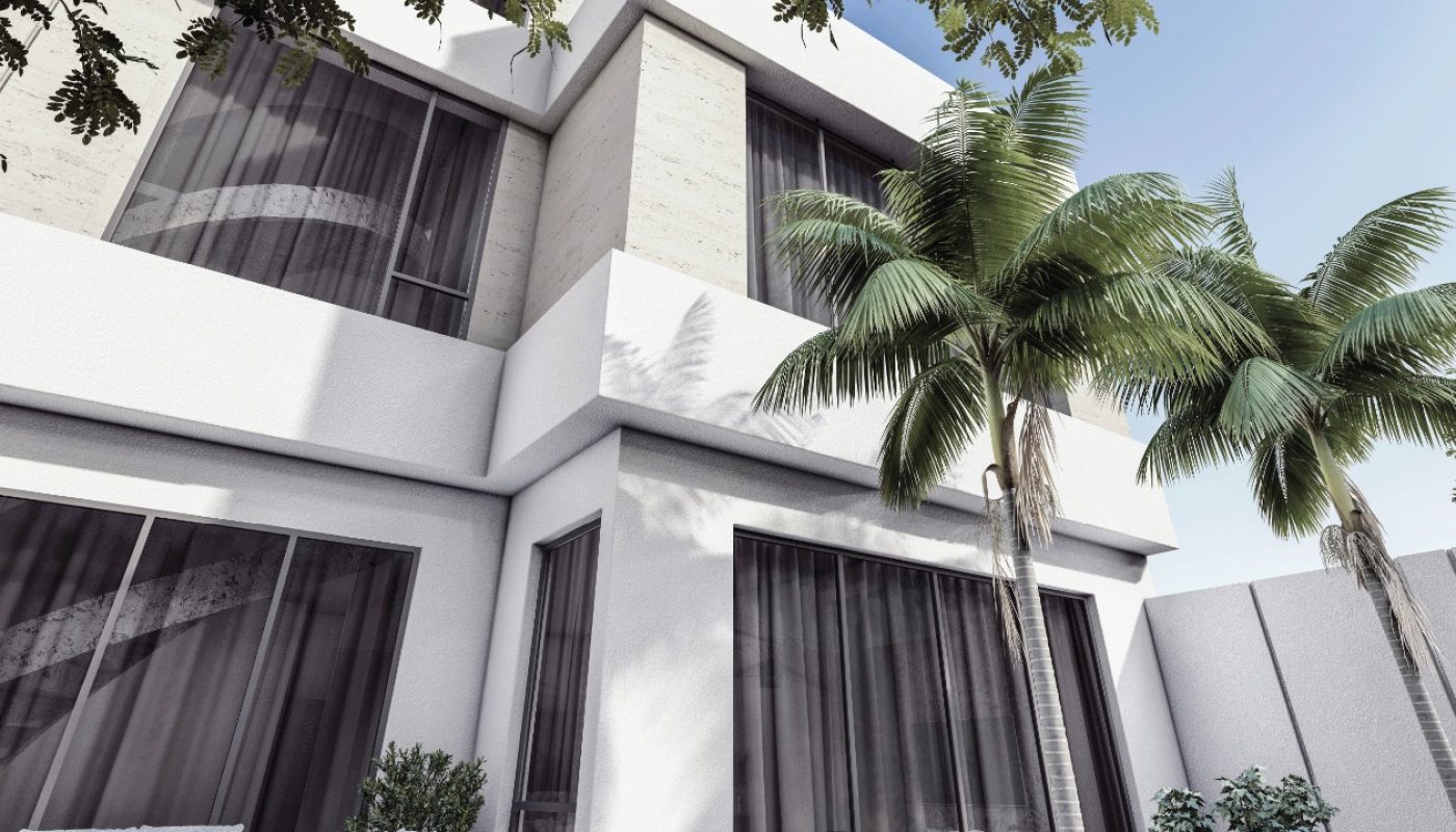Modern white two-story house with large windows, a patio seating area, green lawn, palm tree, and leafy branches overhead under a clear blue sky.