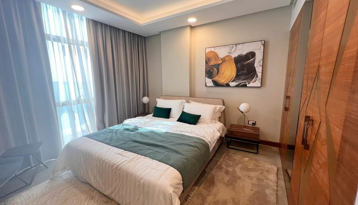 A luxurious bedroom with a bed and a painting on the wall.